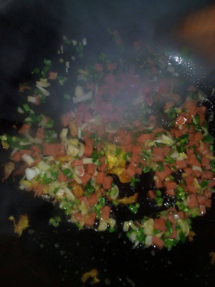 鸡蛋香肠辣酱,锅中油热后, 加入香肠,蒜苗,葱花翻炒, 加入炒好的鸡蛋,适量的花椒粉,姜粉,调好的辣酱,翻炒几下,加入味精。