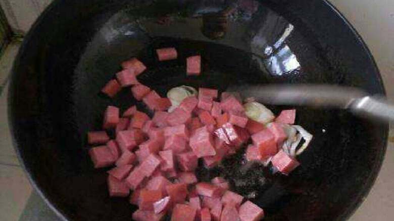 西兰花炒火腿,倒入火腿丁翻炒