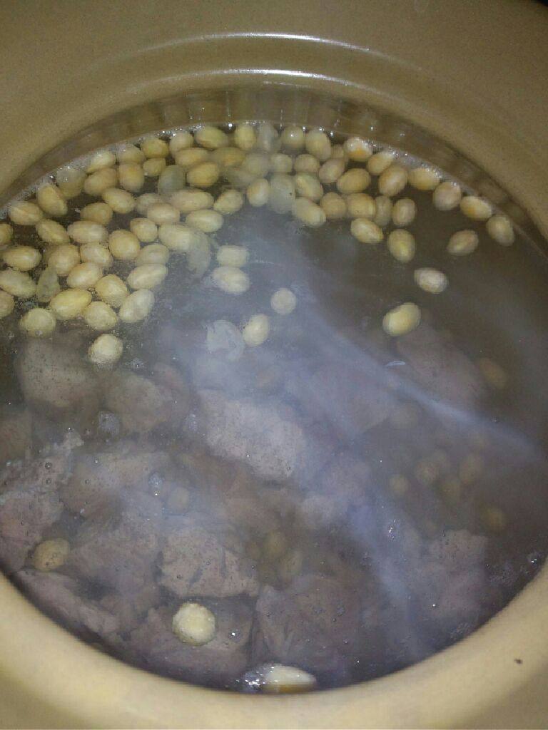 苦瓜骨头汤,拿出沙锅加水烧开把骨头  姜片跟泡好的黄豆放入大火煲开