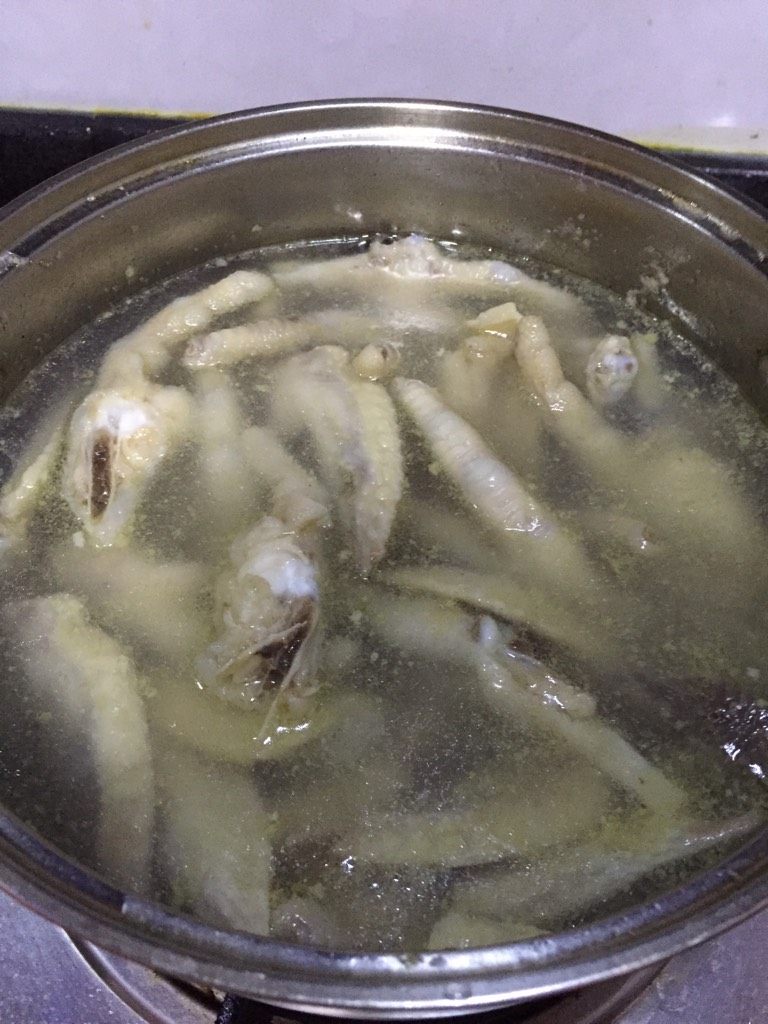 自制泡凤爪,如图将之前腌制好的洗干净入锅里煮好(开锅10分钟左右,期间先放鸡脚煮随后放<a style='color:red;display:inline-block;' href='/shicai/ 96'>鸡翅</a>)