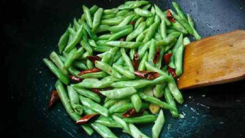 五花肉炒四季豆,倒入四季豆炒1-2分钟；四季豆要多炒一会儿熟透。