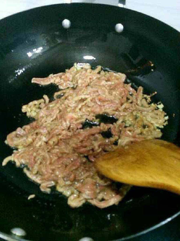 京酱肉丝,油烧热下姜末爆香,再把 肉丝下锅炒散至颜色发白。