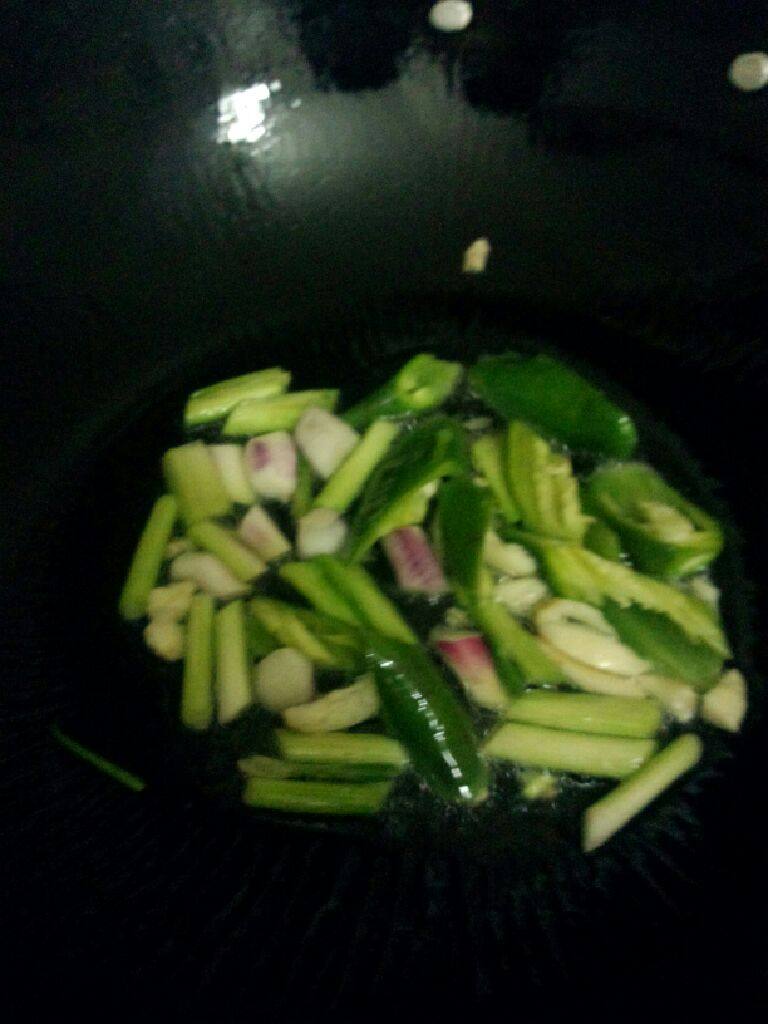 鸡腿肉炒魔芋,锅加油烧热把蒜 葱头 青椒放入炒香