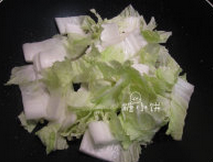 白菜肉丝炒年糕,白菜洗净后切成小片,菜叶和菜杆分开放置,肉丝的余油留在锅内烧热,加入白菜杆翻炒至有些失水变软