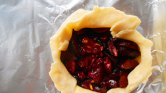 车厘子Galette,取派皮,分成两小份,擀开,在中间放上派馅,向上折起包住派馅就可以了