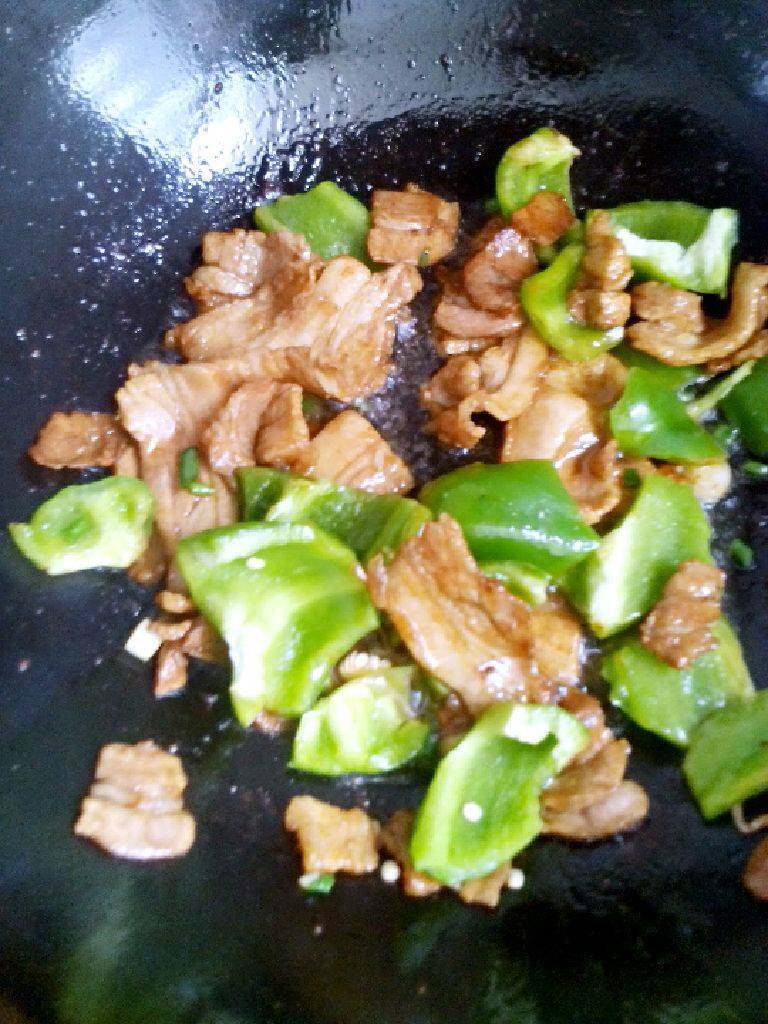 大辣椒炒五花肉,锅中加入适量油，油热后。加入肉酱油炒至变色，加入少许盐。