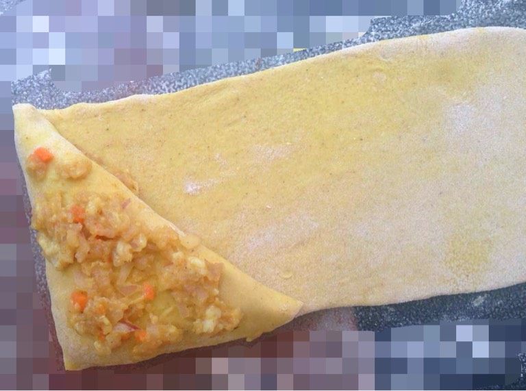 黄金咖喱饺,顺着边折,同时再另一面上敷上一层薄薄的馅料