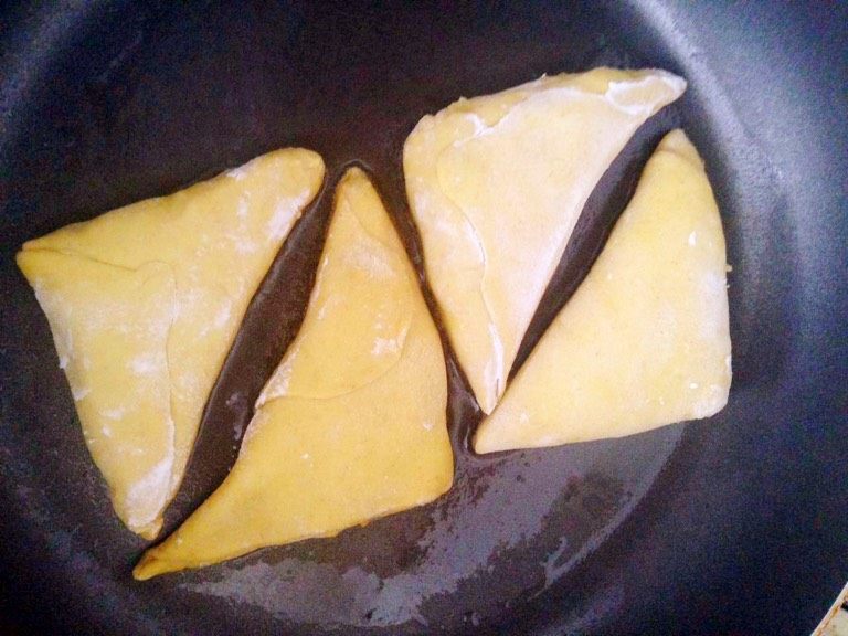 黄金咖喱饺,平底锅刷一层油,小火煎制两面变酥,加入少许水闷一下。等水收干后加入少量油继续煎