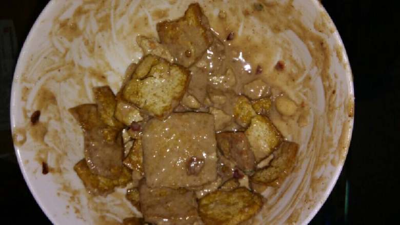 自制炸臭豆腐,拌汁儿。麻酱稀释，根据自己的口味加适量臭豆腐汁儿，把蒜葱切成末儿。加入适量食用盐。放入豆腐，尽量使麻酱淹没豆腐。