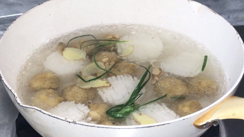 菊花萝卜丸子汤,放入菊花萝卜和肉丸子,煮沸后盖上锅盖,中火煮15分钟