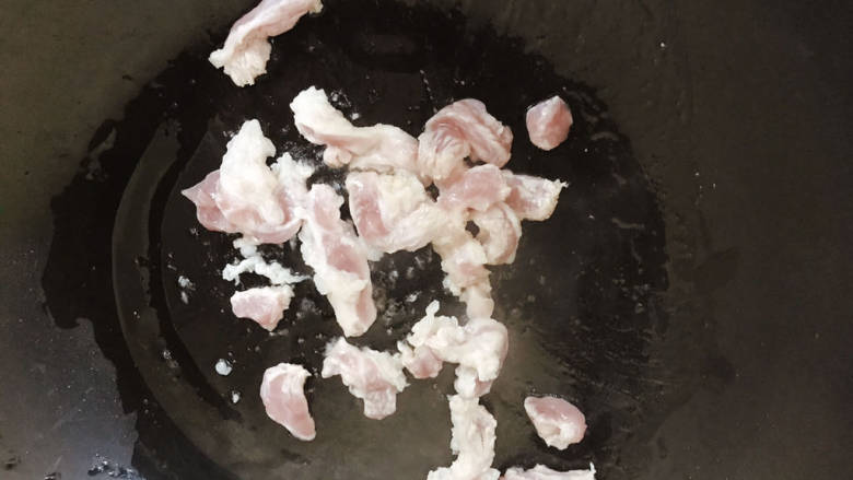 芹菜木耳炒肉丝,起油锅,下肉丝翻炒至变白